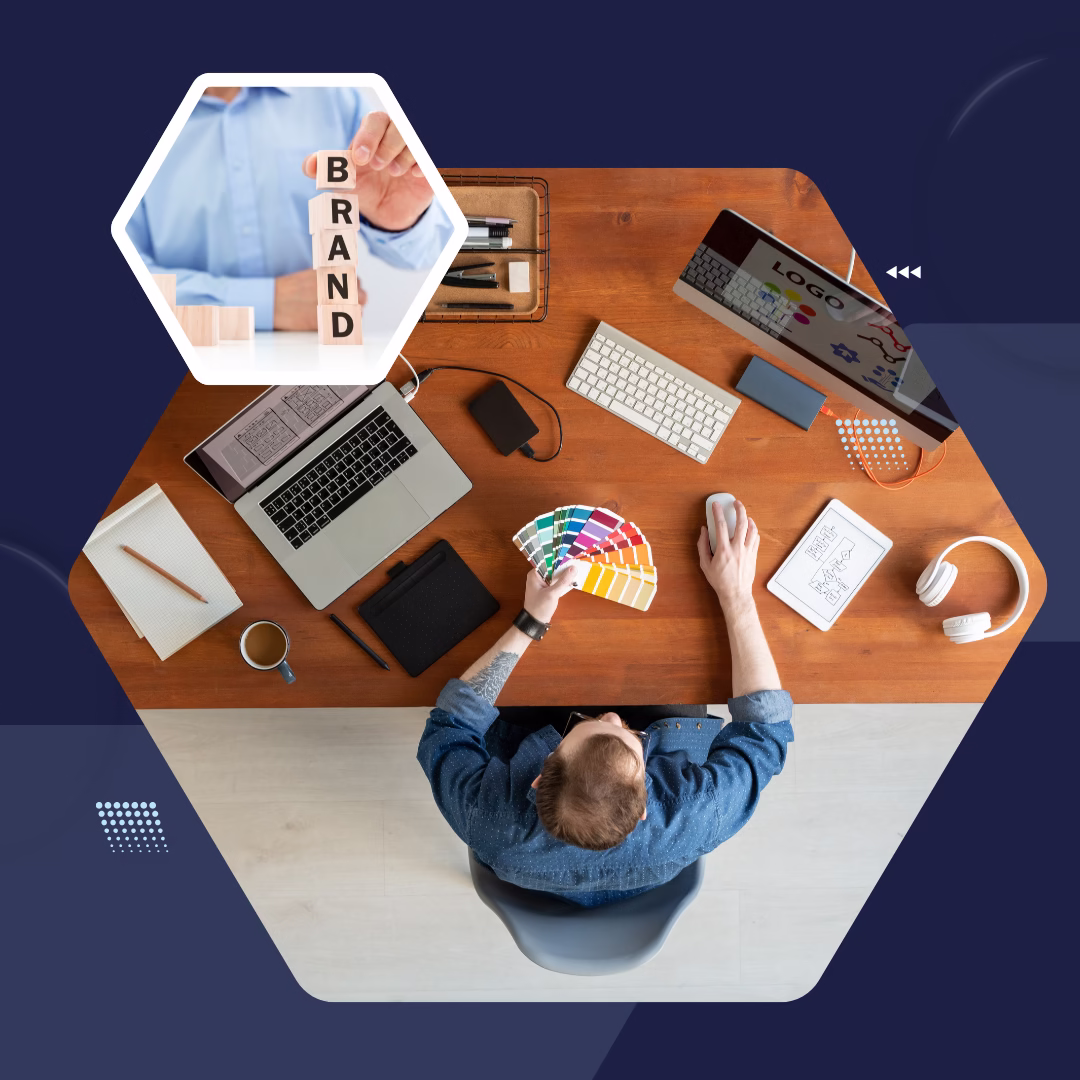 Top view of designer at desk with laptop, color palette, and branding tools symbolizing visual identity and digital trust.